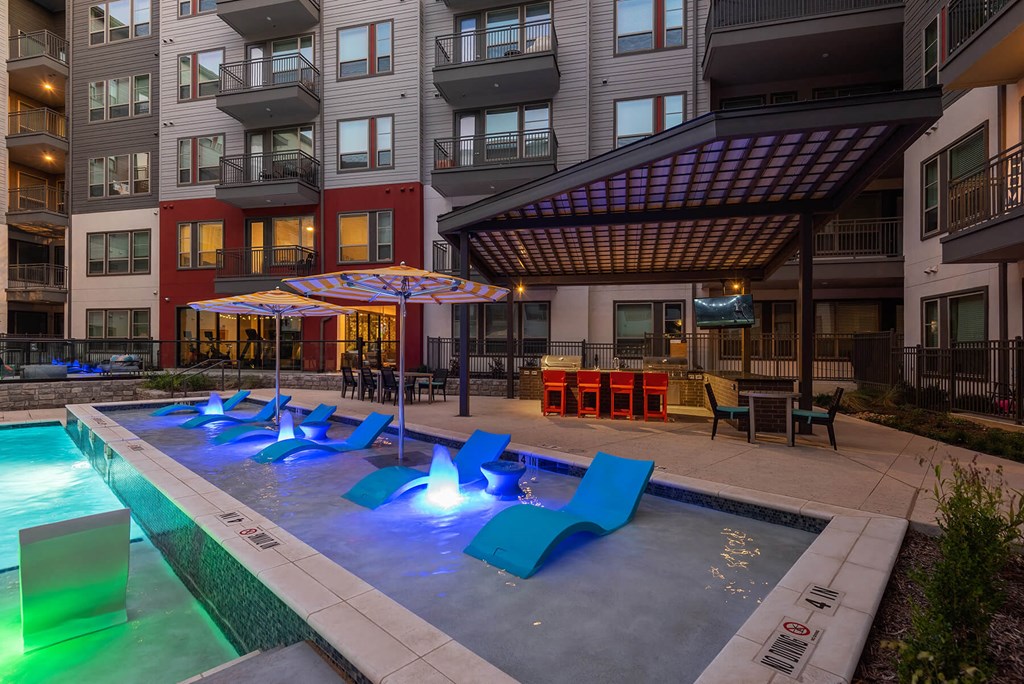 Shallow water pool with tanning chairs at Opal Legacy Central in Plano TX