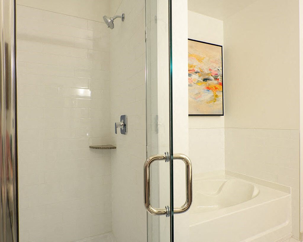 a white bathroom with a shower and a tub