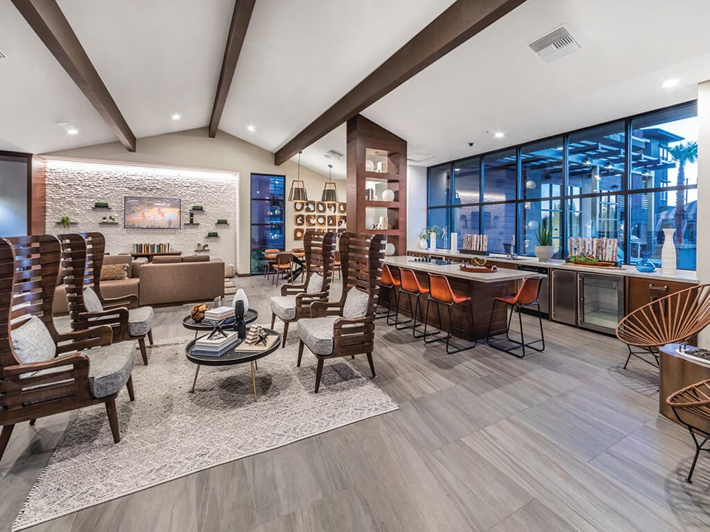 a clubhouse with a bar and chairs and a pool table