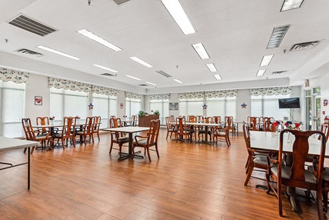 a dining room with tables and chairs and a wood floor