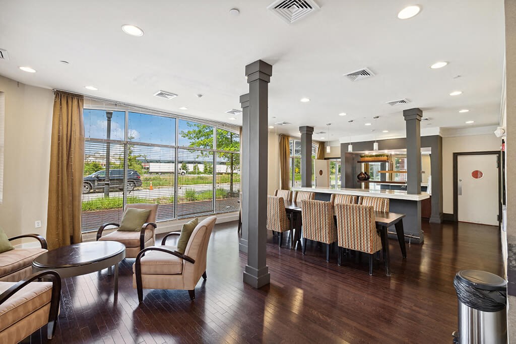 a lobby with a bar and chairs and a large window