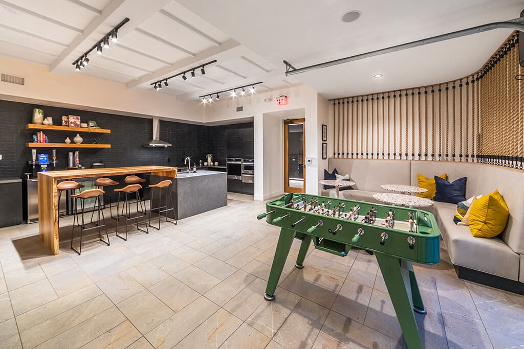 a game room with a pool table and a bar