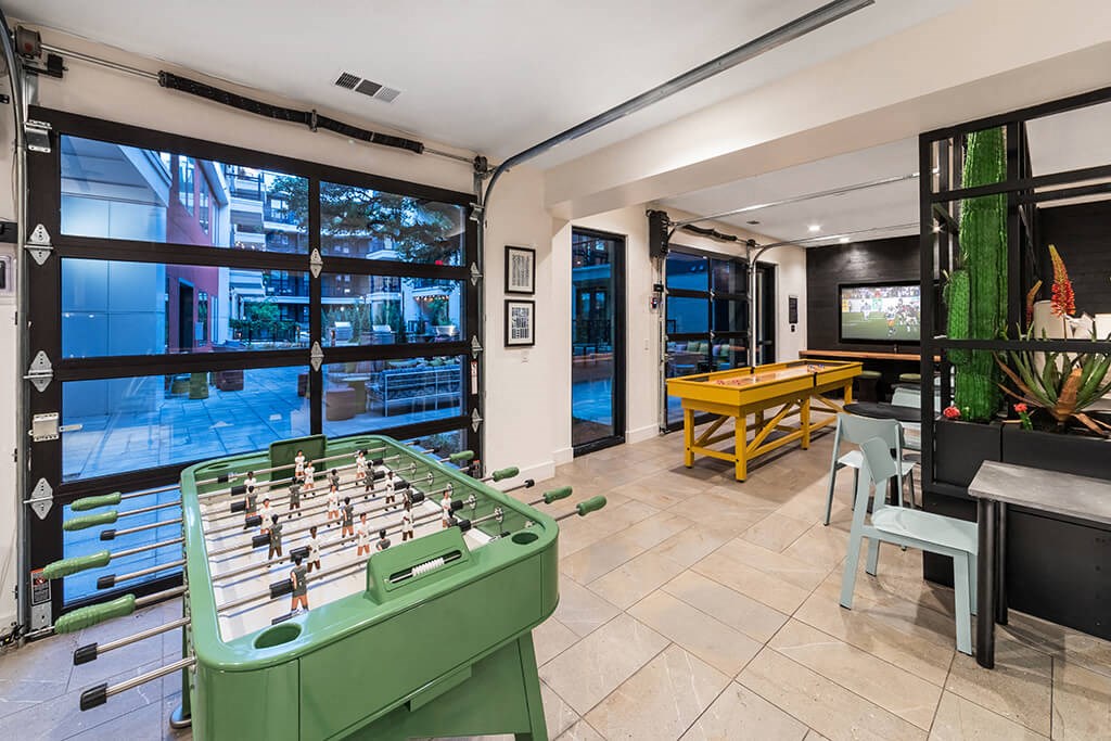 a game room with a foosball table and a pool table