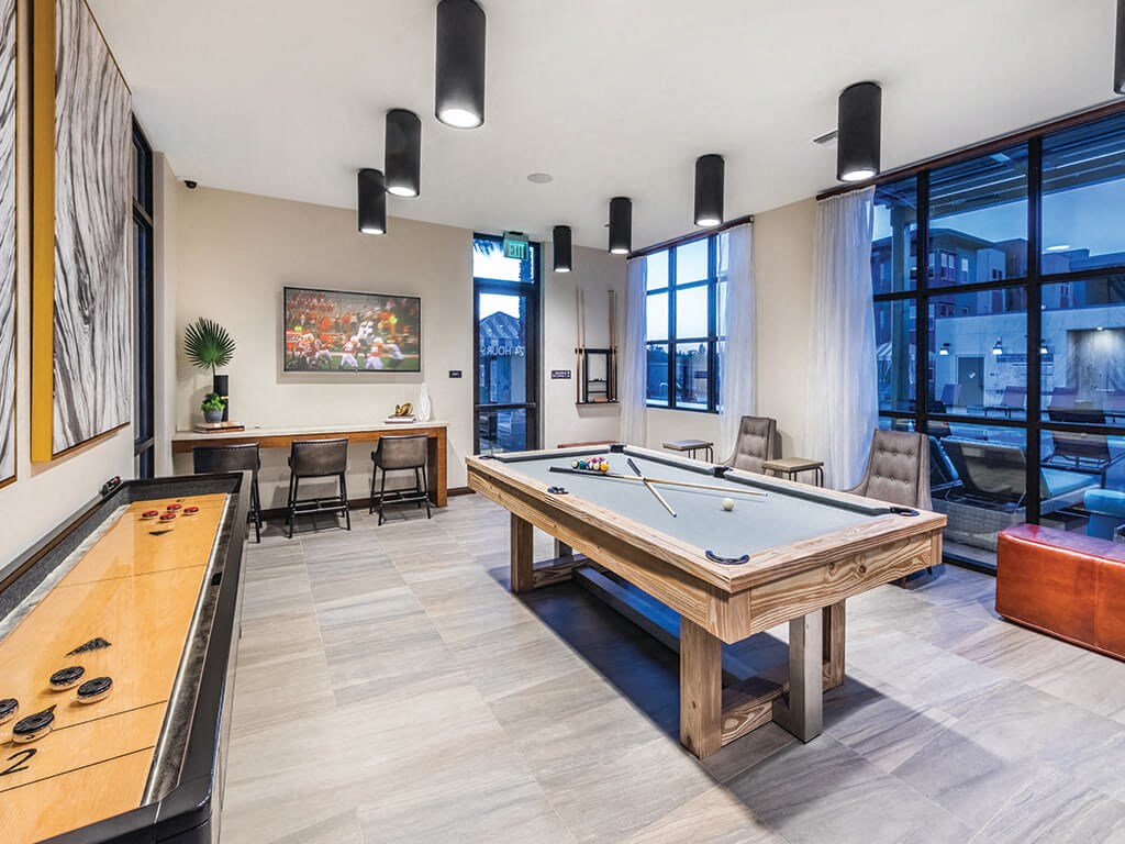 clubhouse with pool table and ping pong table at the central apartments near downtown minneapolis m