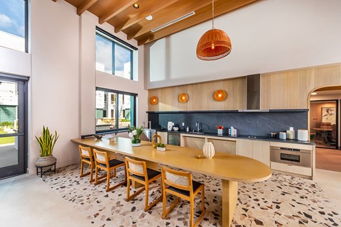 A modern kitchen with a wooden table and chairs.
