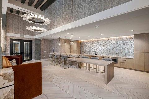 A modern kitchen with a long table and chairs.