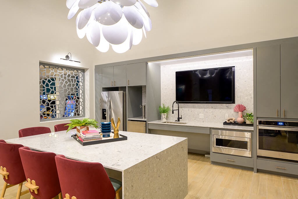 a kitchen and dining room with a table and a tv