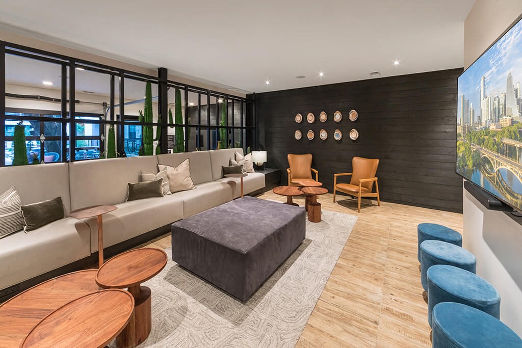 a living room with couches and chairs and a television