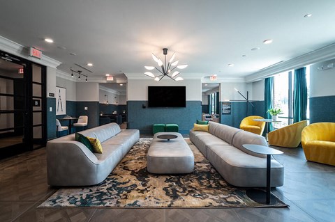 Social lounge seating room with tv at The Belhaven in Alexandria VA
