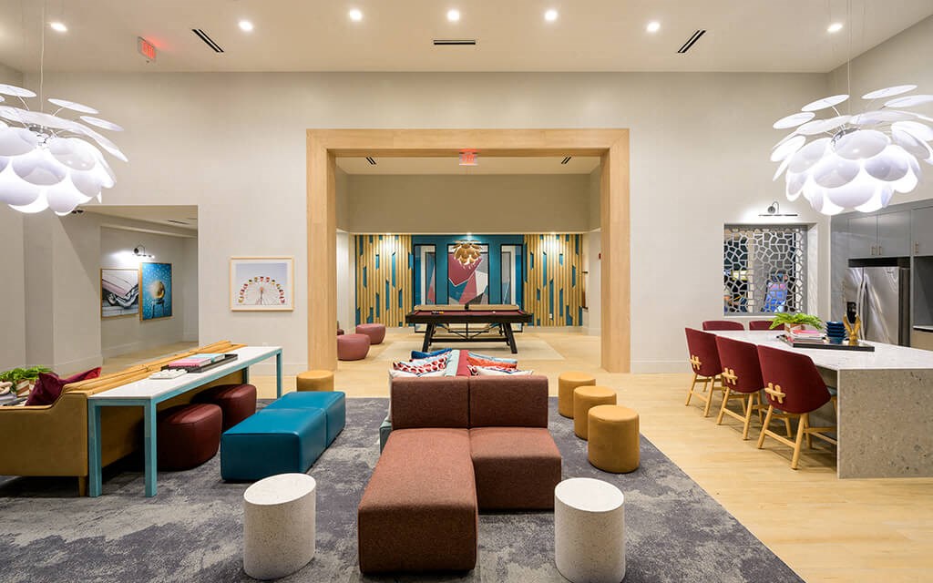 a hotel lobby with couches and tables and a bar