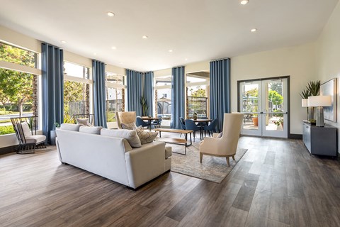 A spacious living room with a white couch and a wooden floor.