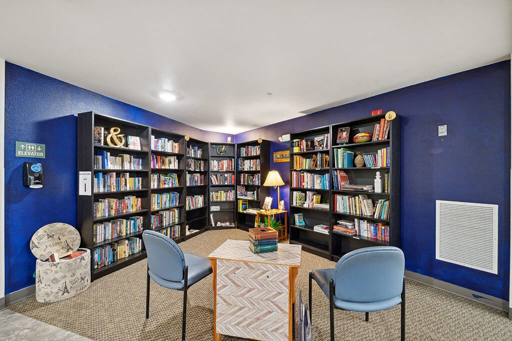 Social lounge reading area at Woodlands at Forbes Lake Apartments in Kirkland WA