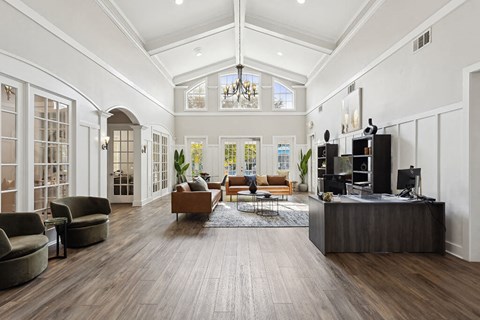 a living room with white walls and a ceiling with a chandelier