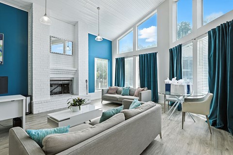 A modern living room with a grey sofa and a fireplace.