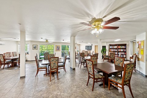 a dining room with tables and chairs and a ceiling fan