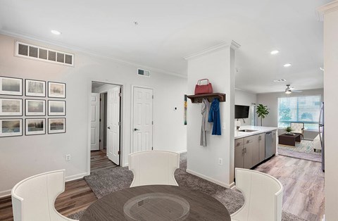 A modern kitchen with a dining table and chairs.