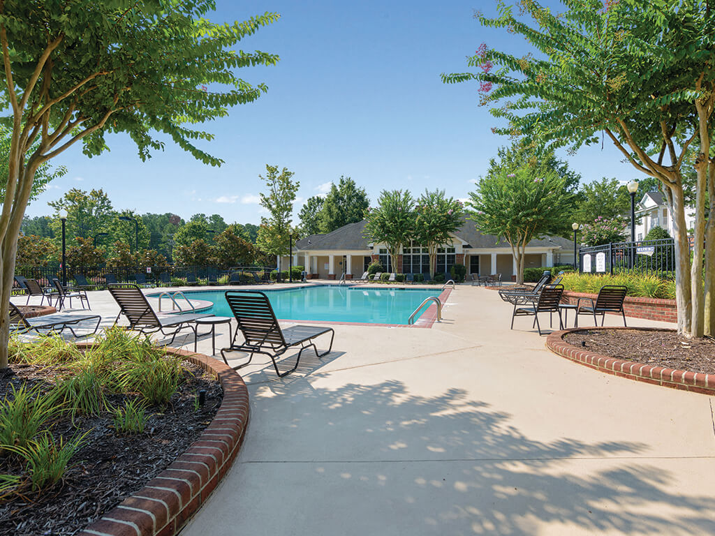 Swimming pool lounge chairs at Falls Pointe Apartments in Durham NC