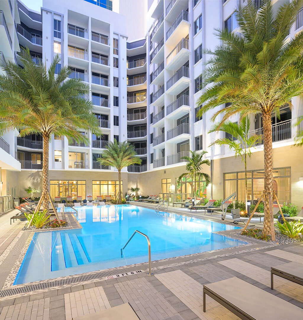 Swimming pool at dusk at Coasterra Apartments in Fort Lauderdale FL