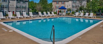 Swimming pool with chairs at Riverwoods, Riverwoods at Towne Square, and Riverwoods at Lake Ridge in Woodbridge VA - Photo Gallery 9