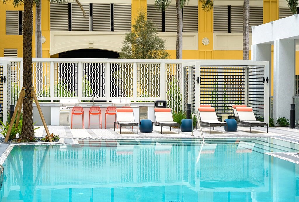 Swimming pool lounge chairs at Coasterra Apartments in Fort Lauderdale FL