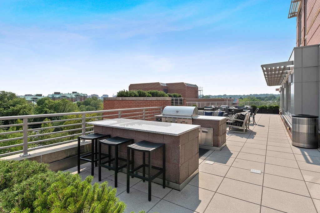 Outdoor terrace grilling area at Bradley Braddock Road Station Apartments in Alexandria VA