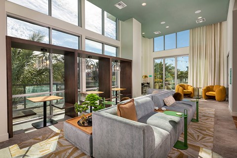 A modern living room with a large grey couch and a coffee table.