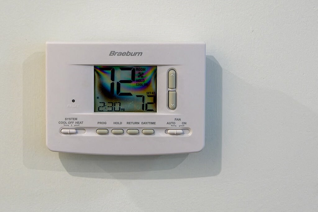 an electronic clock on a white wall