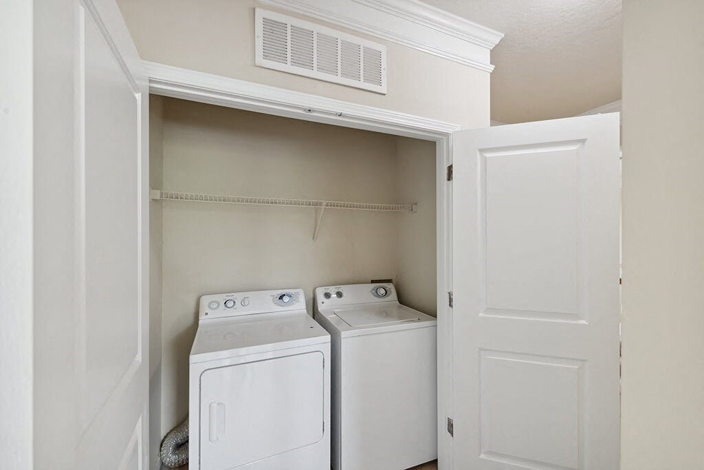 a washer and dryer in a laundry room with white doors