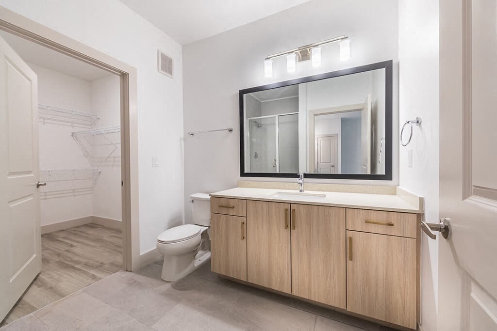 Bathroom with attached closet at 1900 Parmer Apartments in Austin TX