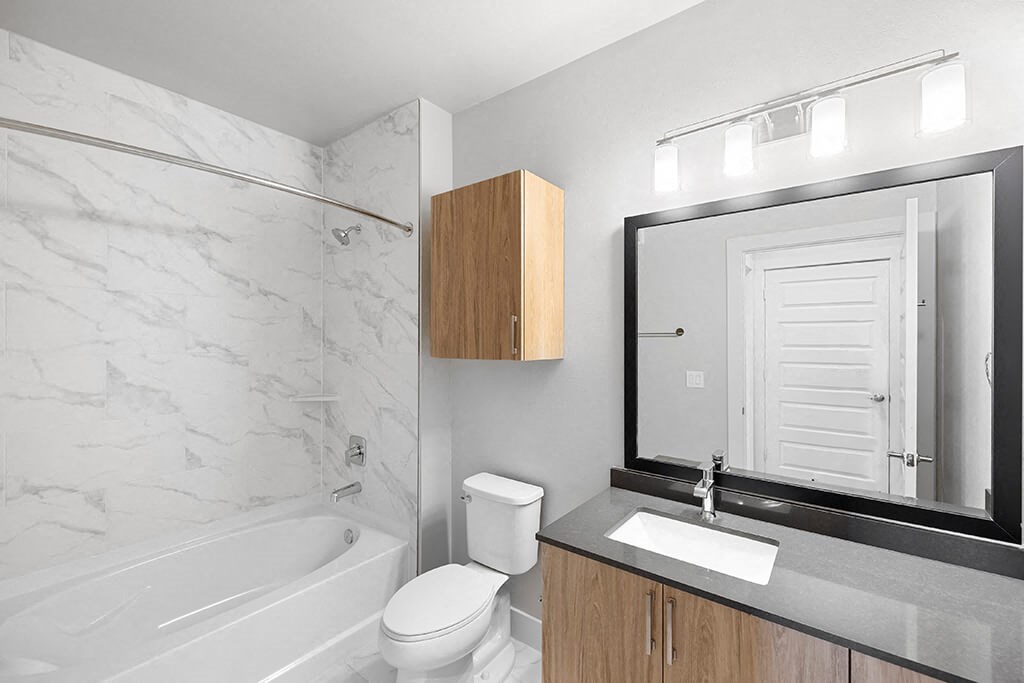 Herringbone Design Package Bathroom at East Bend Apartments in Houston TX