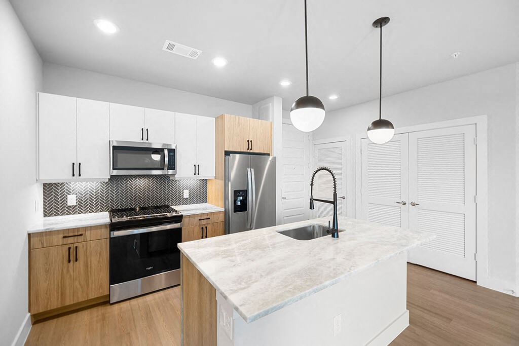 Herringbone Design Package Kitchen Angled at East Bend Apartments in Houston TX