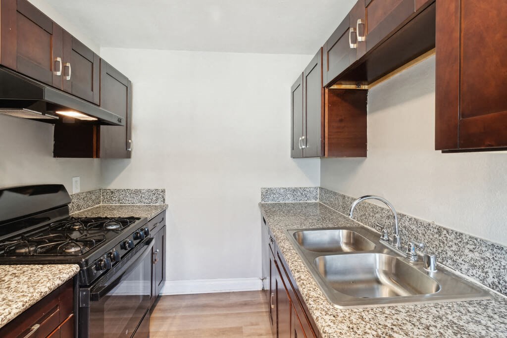 Vacant kitchen with stove at Park Crest Apartments in San Diego CA