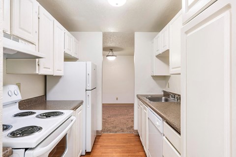 a kitchen with white appliances and white cabinets