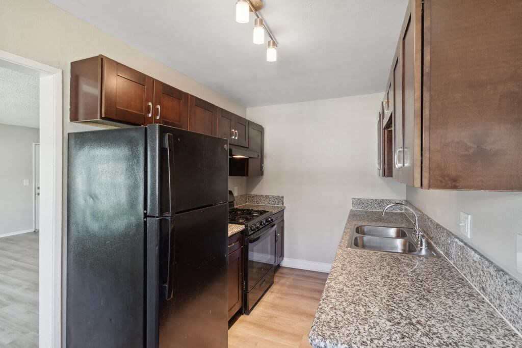 Kitchen with black appliances at Park Crest Apartments in San Diego CA