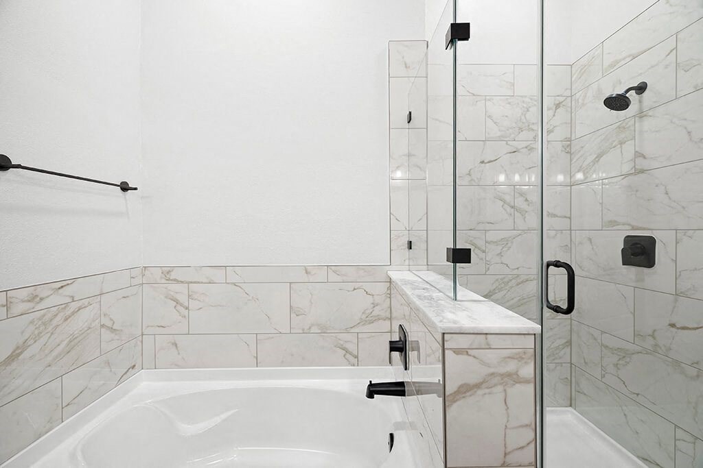 Penthouse Design Package Primary Bathroom Bathtub and Shower at 1810 Main Apartments in Houston TX