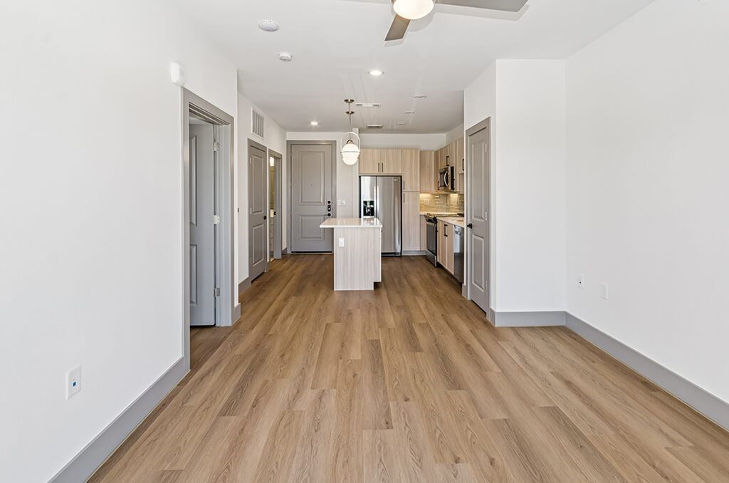 Vacant Sage Design Package Living and Kitchen at The Waylon Apartments and Townhomes in McKinney TX