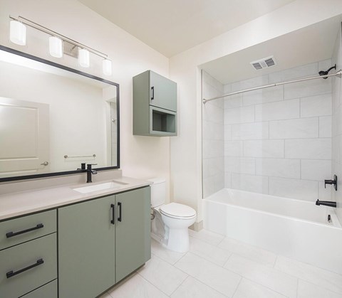 A white bathroom with a sink, toilet, and bathtub.
