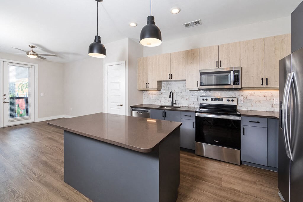 a kitchen with stainless steel appliances and a counter top