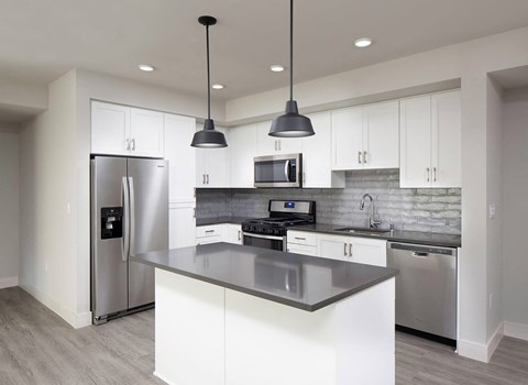 Vacant Slate Design Package Kitchen with island at The Seaton Apartments in San Diego CA