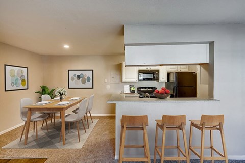 a kitchen and dining area with a table and chairs
