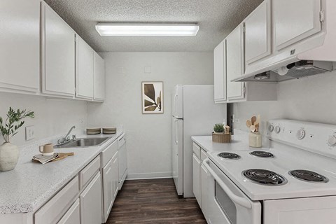 a kitchen with white appliances and white cabinets