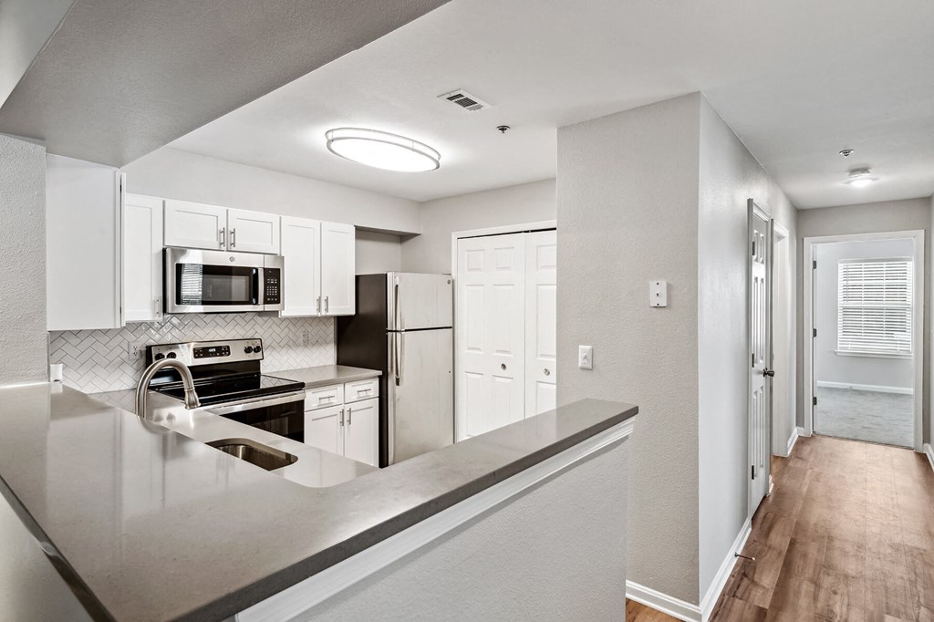 Kitchen counter and view of hallway at England Run Apartments in Fredericksburg VA