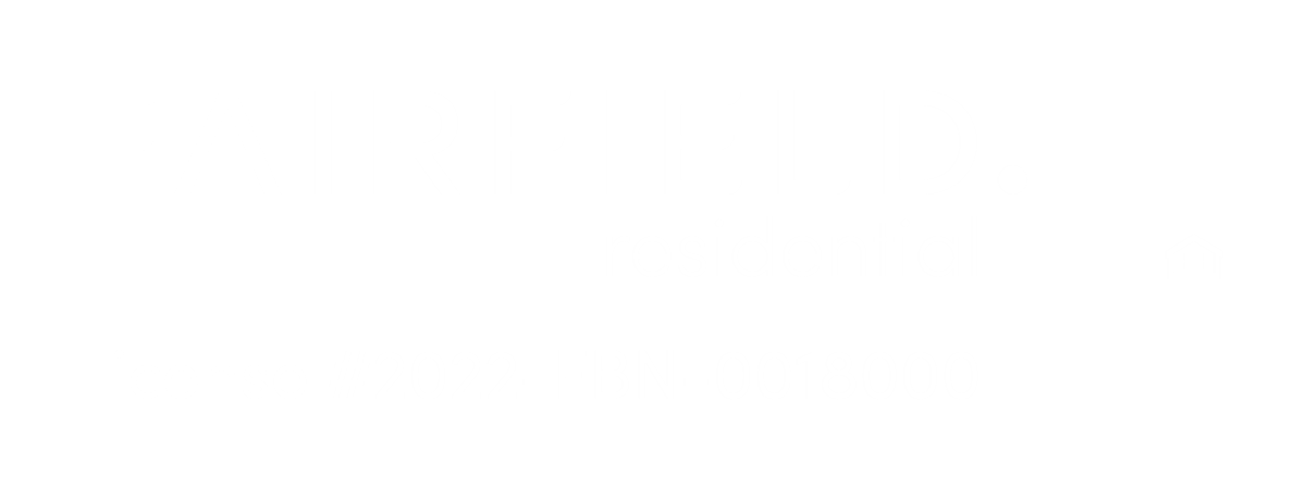 A green sign with the word Fairfield and a house icon indicating residential area.