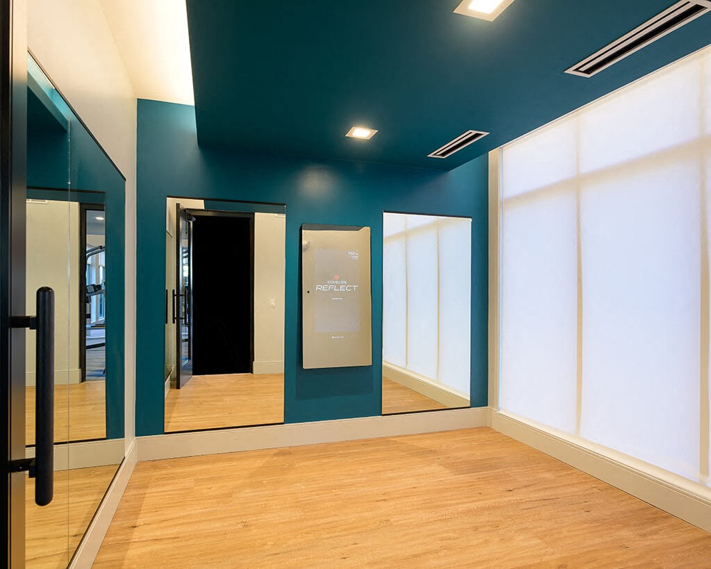 a room with mirrors on the wall and a wood floor