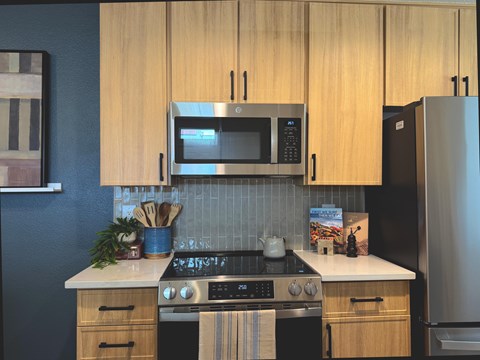 A kitchen with wooden cabinets and a stove top oven.