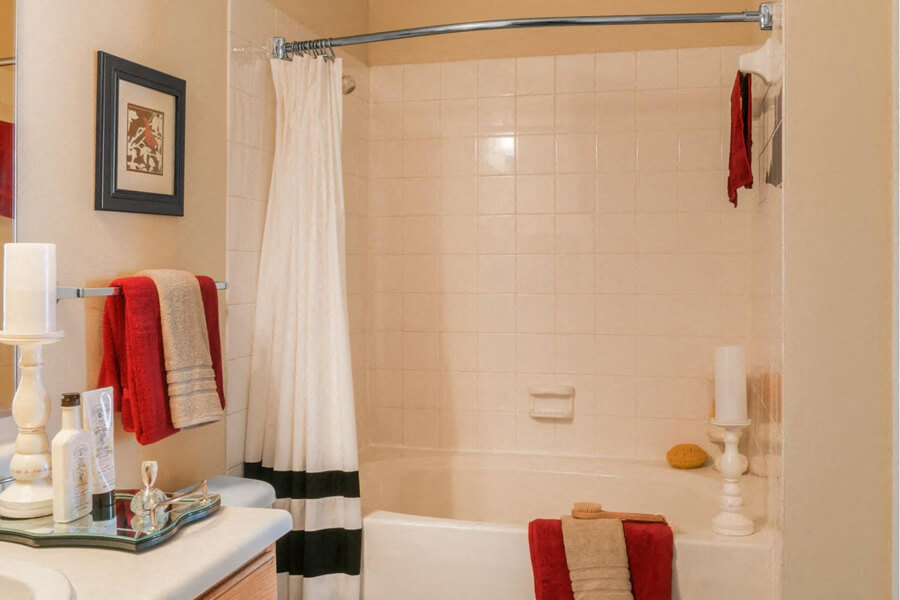 Bath tub with tile surround at River Pointe at Den Rock Apartments in Lawrence, MA