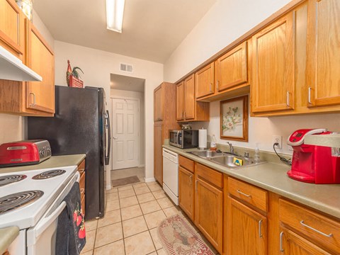 a kitchen with a stove sink and refrigerator