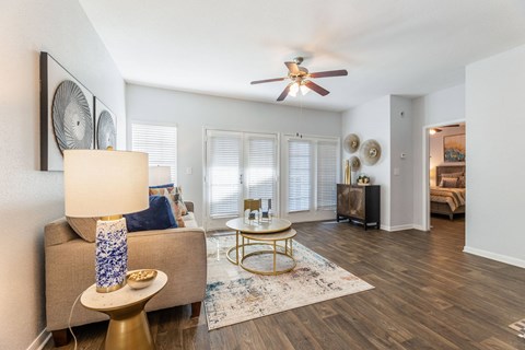 a living room with a couch and a ceiling fan
