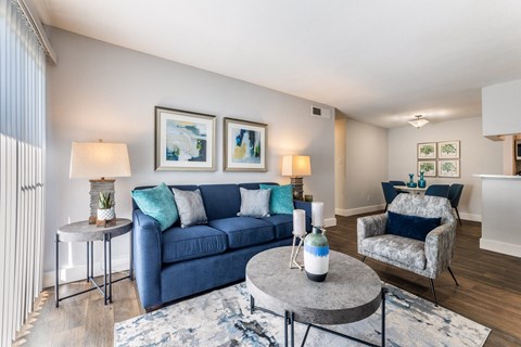 a living room with a blue couch and a coffee table