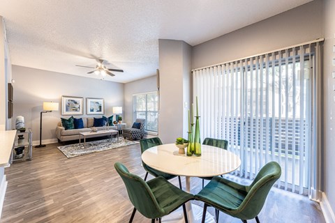 an open living room with a dining room table and chairs